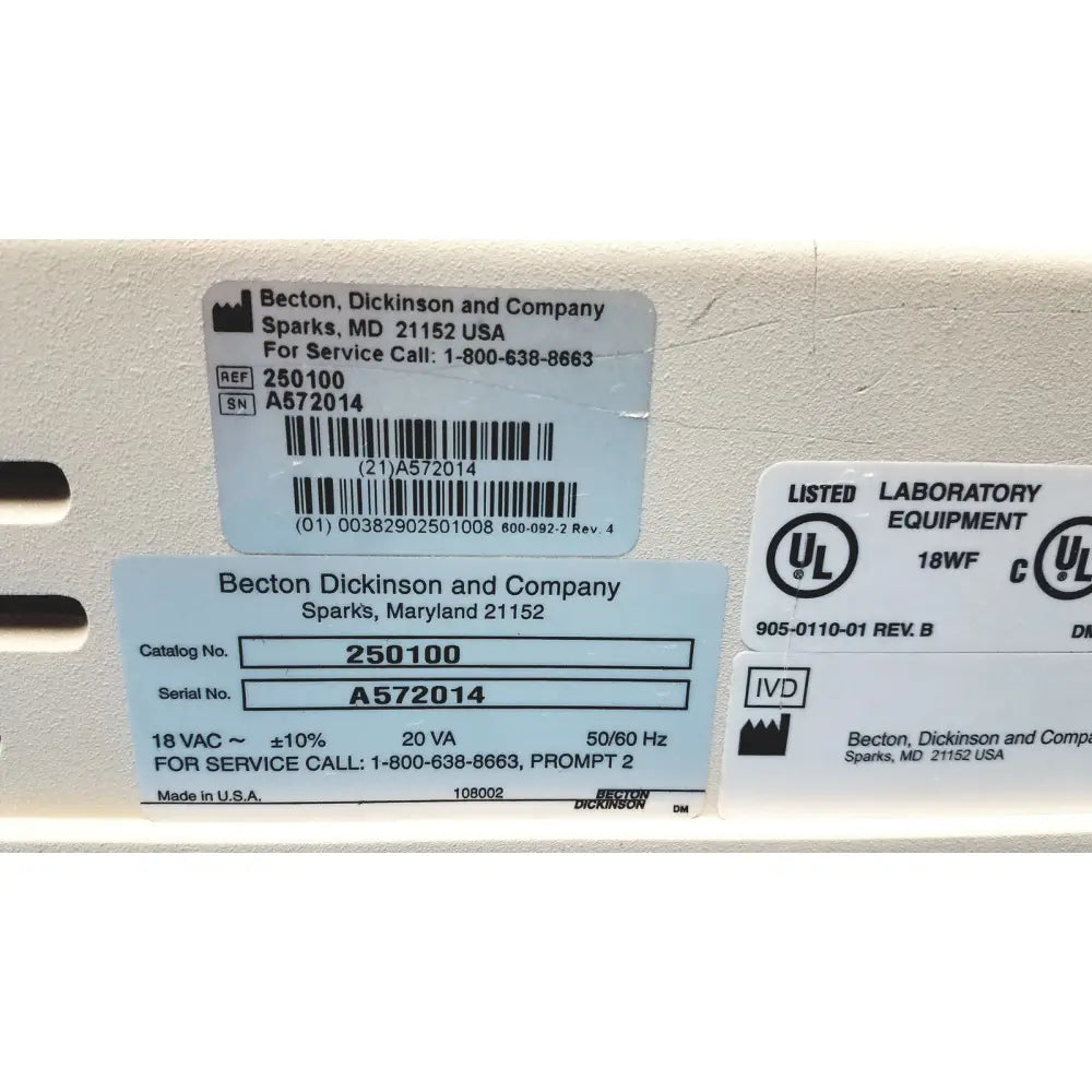 White plastic becton dickinson laboratory equipment label with black text and barcode on becton dickinson microprobe processor