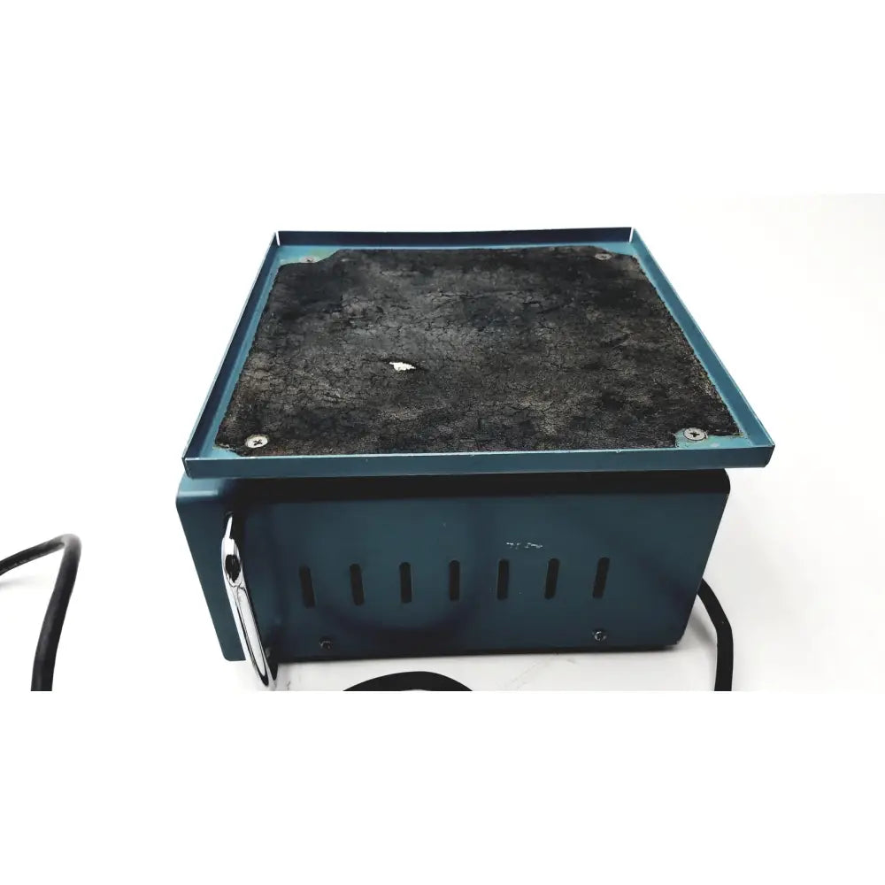 Teal rectangular electric heating pad with black textured surface and ventilation slits on the side of bellco orbital shaker