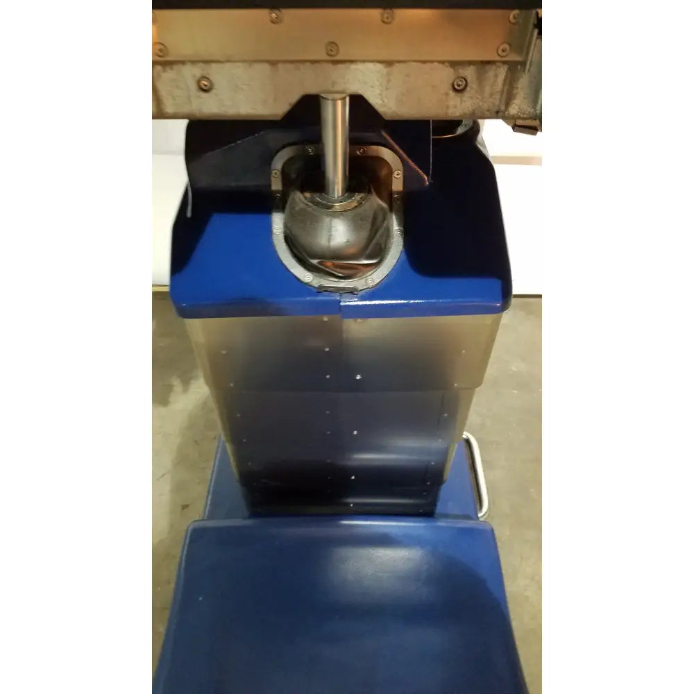 Blue berchtold d850 operon surgical table with a metallic spherical component at its center for precise adjustments