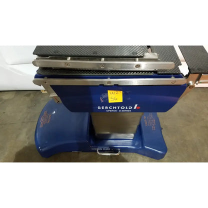 Berchtold d850 operon surgical table with blue d-series dental operatory featuring carbon fiber textured top and stainless steel frame