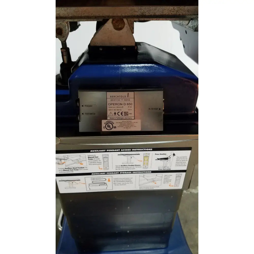 Blue berchtold d850 operon surgical table with metallic label and instructional diagrams for precise medical use