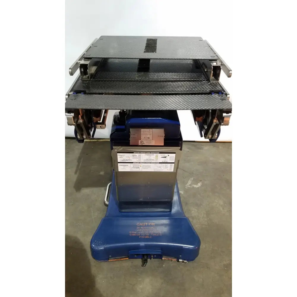 Blue berchtold d850 operon surgical table with black carbon fiber top and metallic frame for medical use