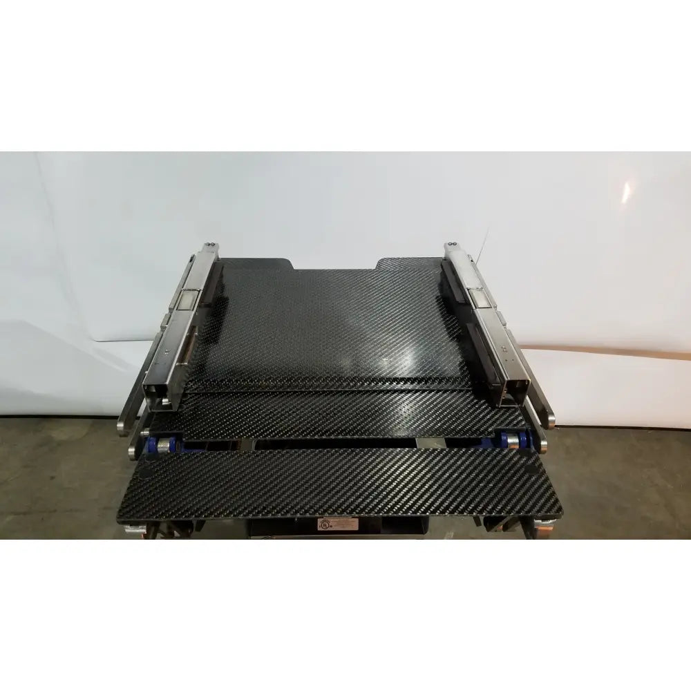 Black carbon fiber tray with metallic side rails and blue rollers for berchtold d850 operon surgical table