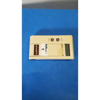 Beige plastic Bio-Dynamics Accu-Chek bG blood glucose monitor with two circular buttons and a small rectangular screen