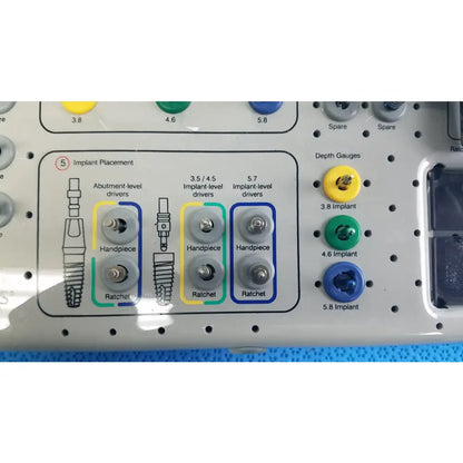 Gray plastic tray with organized color-coded handles holding bio horizons tapered internal dental implant drivers and depth gauges