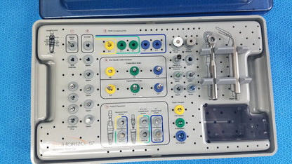 Gray plastic surgical tray with organized color-coded drill bits and titanium instruments from Bio Horizons tapered internal dental kit