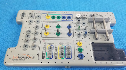 Gray plastic bio horizons tapered internal dental implant surgical kit with color-coded internal dental components and labels