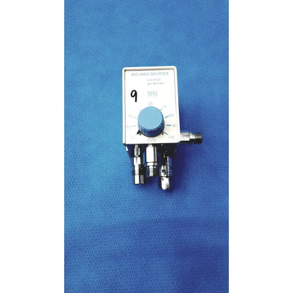 White rectangular medical air oxygen blender with blue dial and metallic ports by bio-med devices for respiratory gas mixing