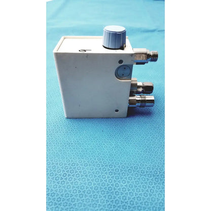 White rectangular Bio-Med Devices 2001 air oxygen blender with silver knob and three metallic threaded ports for medical use