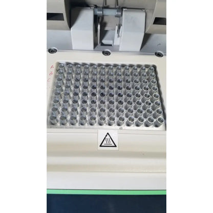 A white plastic microplate tray with 96 wells holding clear tubes in a bio-rad mycycler thermal cycler 580br