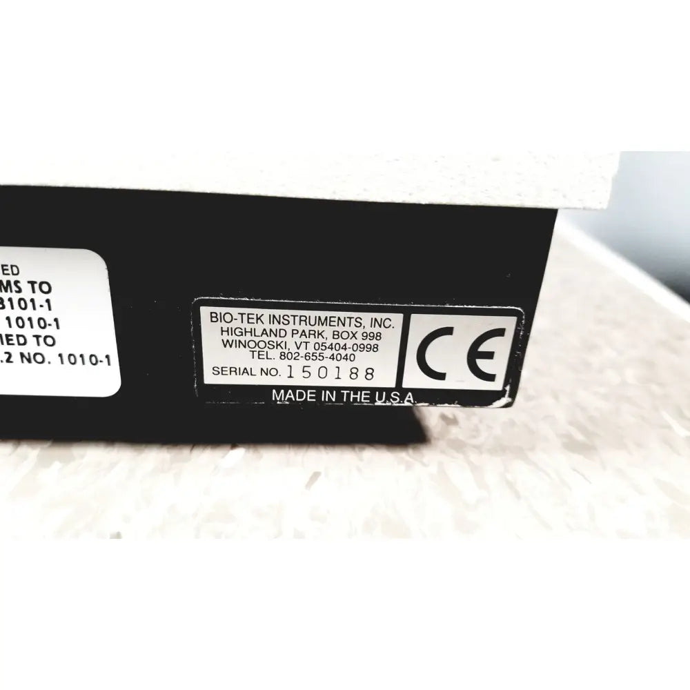 Black rectangular label with white text and ce mark on the back of bio-tek instruments elx800 universal microplate reader