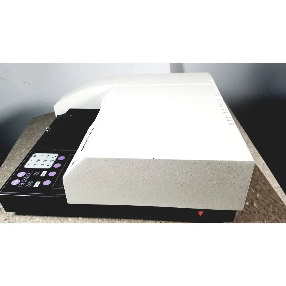 White and black bio-tek instruments elx800 universal microplate reader with purple keypad buttons for absorbance measurement