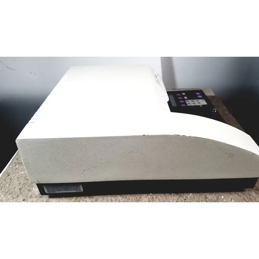 White rectangular bio-tek instruments elx800 universal microplate reader with black control panel and purple buttons