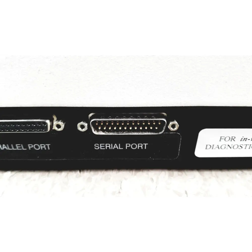 Black rectangular diagnostic adapter with parallel and serial metal ports on back of bio-tek instruments elx800 universal microplate reader