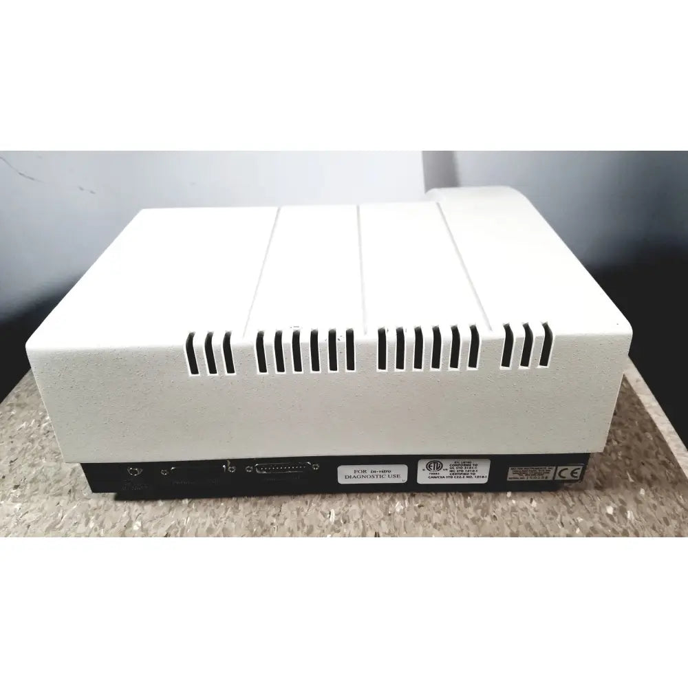 White rectangular bio-tek instruments elx800 universal microplate reader with black ventilation slits and ports on black base