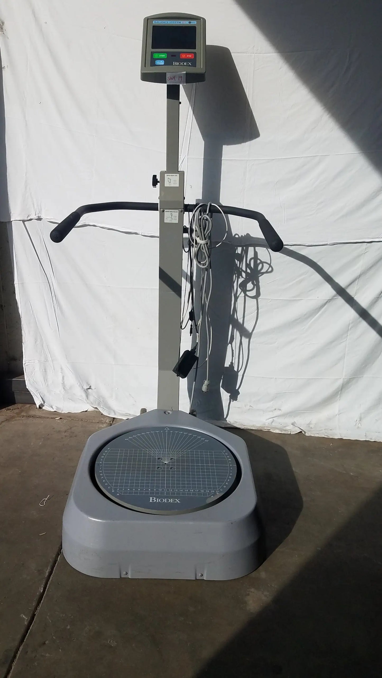 Gray biocell brand standing scale with digital display and handlebars for balance assessment serial number 0705499