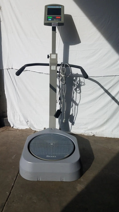 Gray biocell brand standing scale with digital display and handlebars for balance assessment serial number 0705499