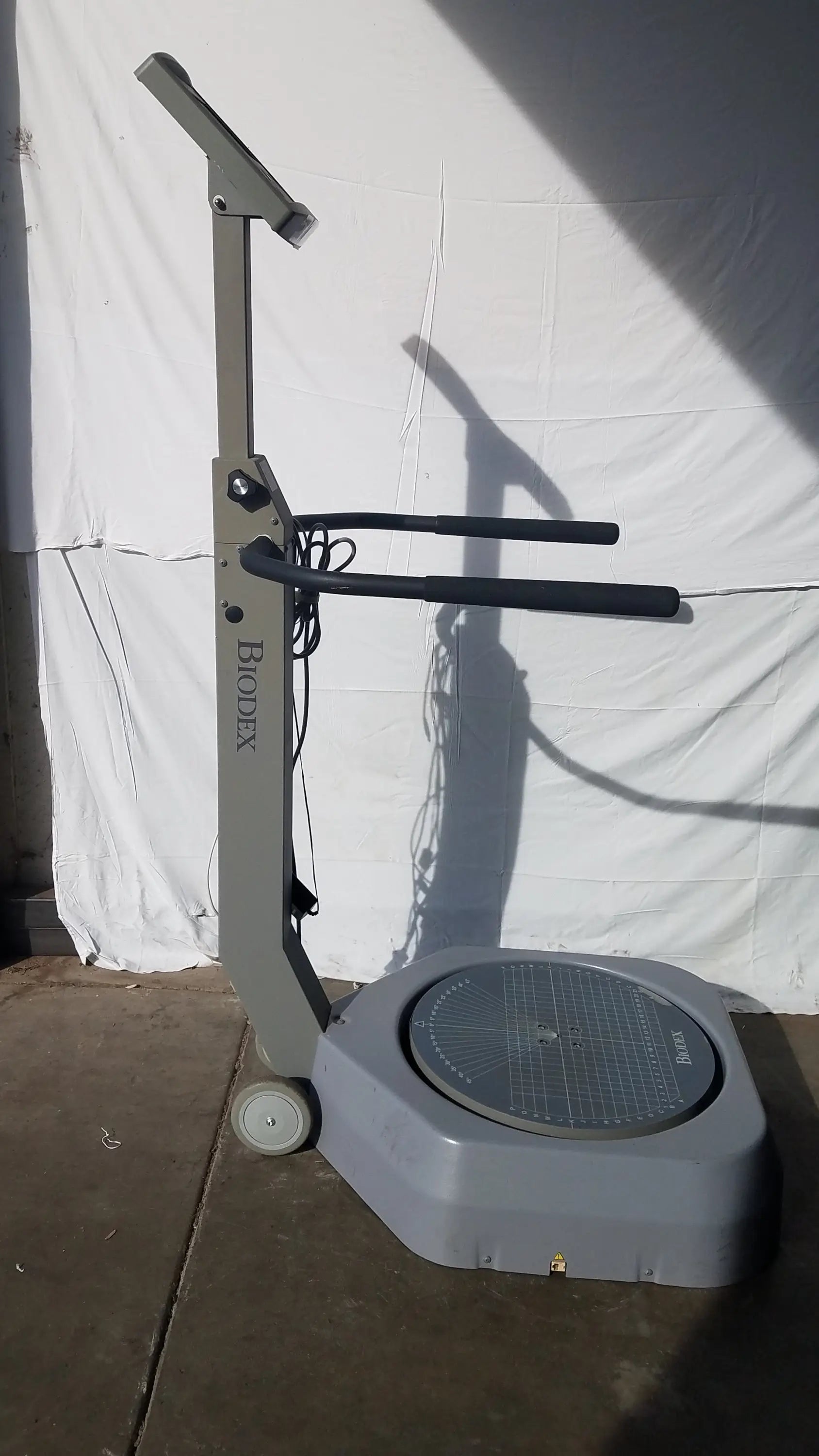 Gray biodex 950-300 balance system sd 115v with circular platform and adjustable handlebars for balance assessment serial number 0705499