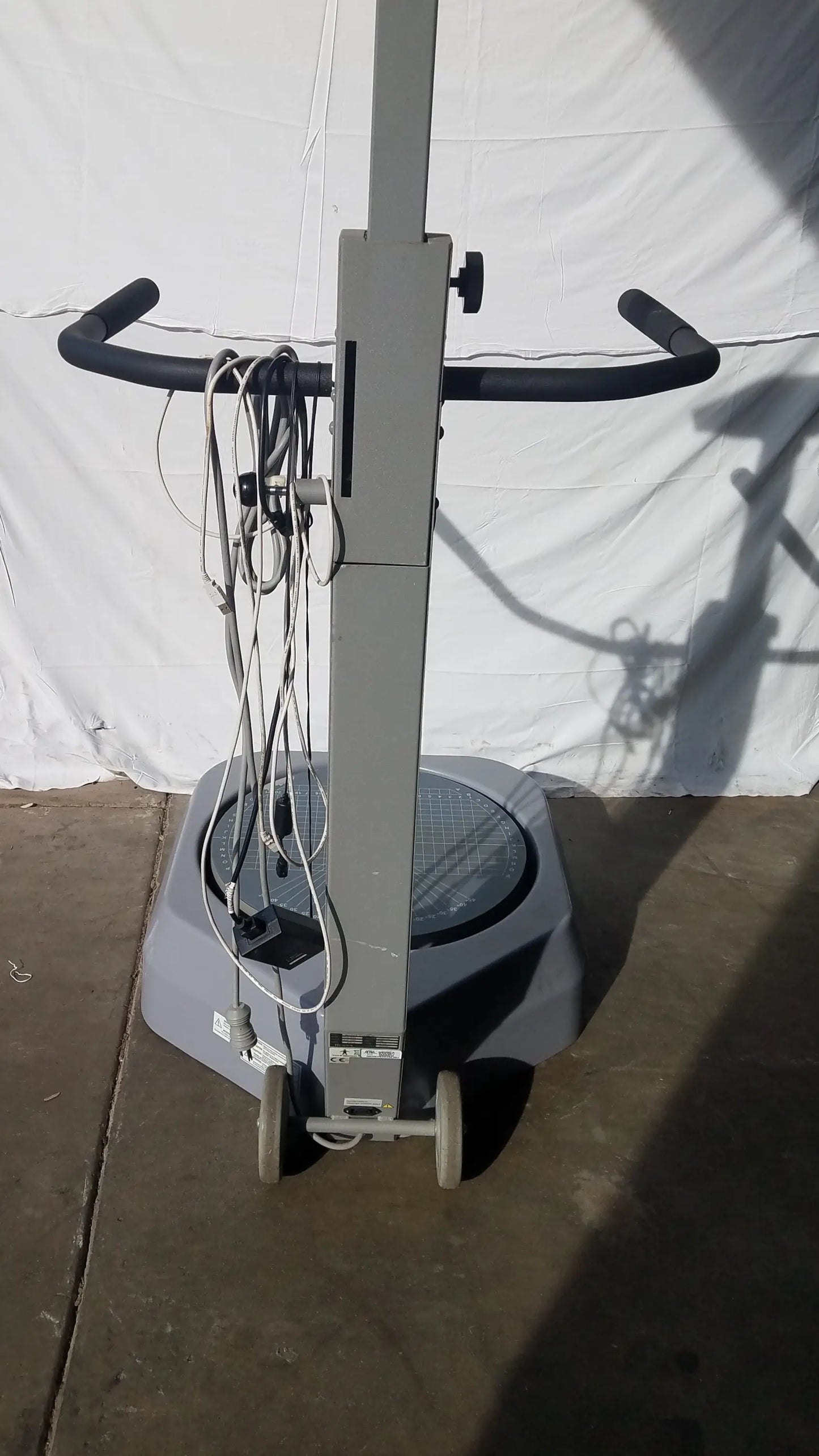 Gray industrial floor polisher with black handlebars and wheels for balance assessment serial number 0705499 visible