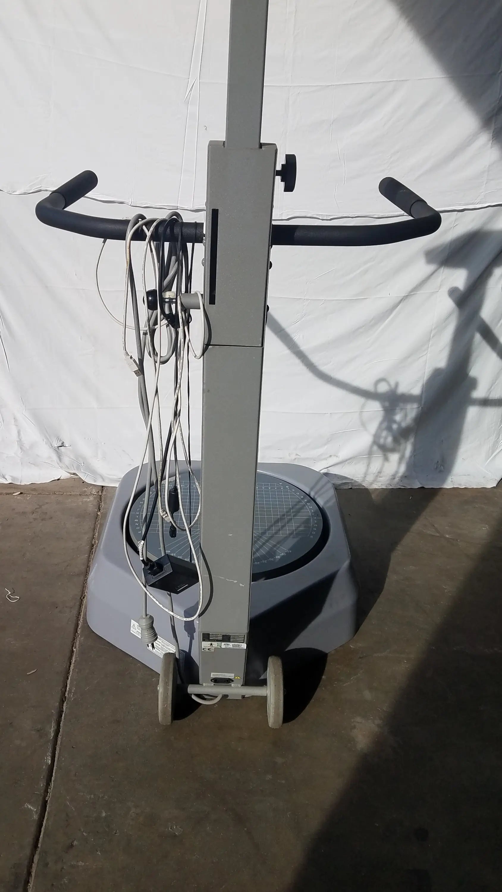 Gray industrial floor polisher with black handlebars and wheels for balance assessment serial number 0705499 visible