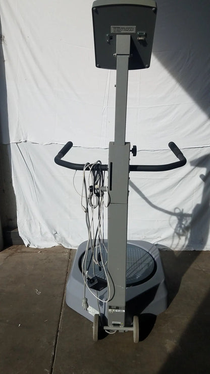 Gray industrial floor polisher with black handlebars and rectangular control panel shown with biodex 950-300 balance system serial number 0705499