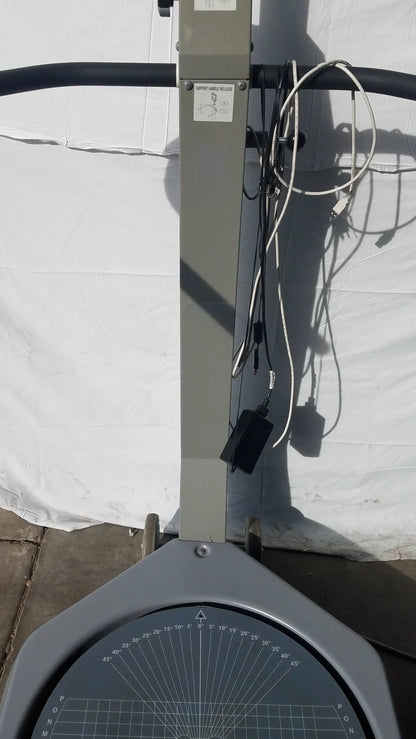 Gray metal protractor with circular degree dial on vertical stand for balance assessment biodex 950-300 sn 0705499