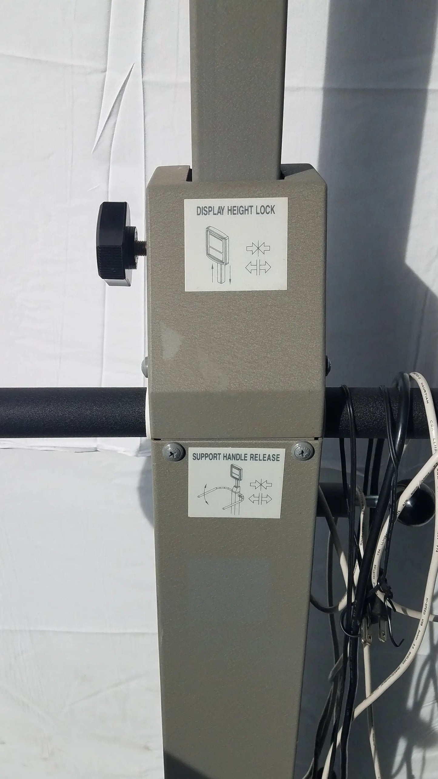 Gray metal display stand with black adjustment knobs and labeled control panels for biodex 950-300 balance assessment serial number 0705499