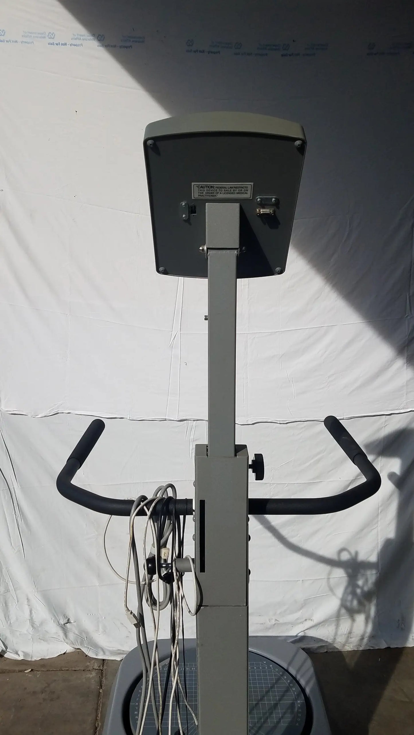 Gray metal biodex 950-300 balance system exercise bike with black handlebars and digital display panel serial number 0705499