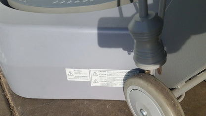 Gray plastic biodex 950-300 balance system sd with circular dial and serial number for balance assessment on wheeled base