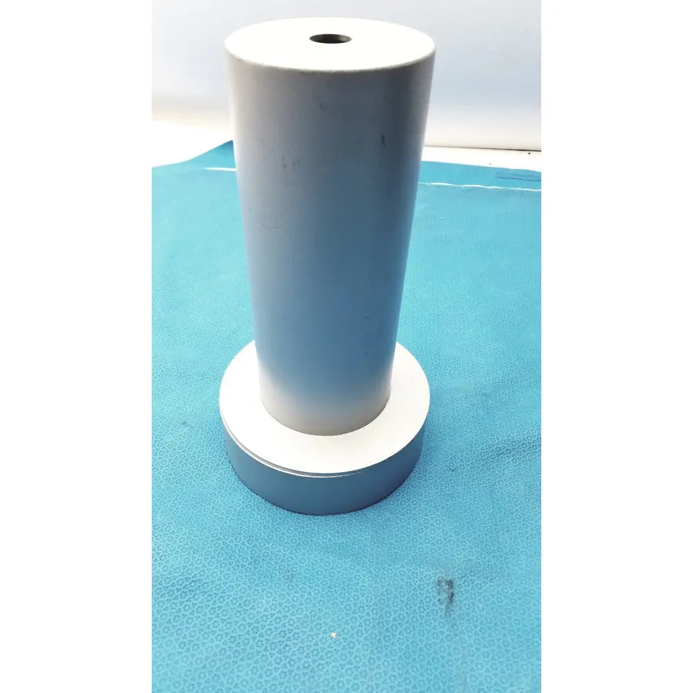 White cylindrical biodex medical systems wipe test counter with central hole and matching circular base for systems wipe test