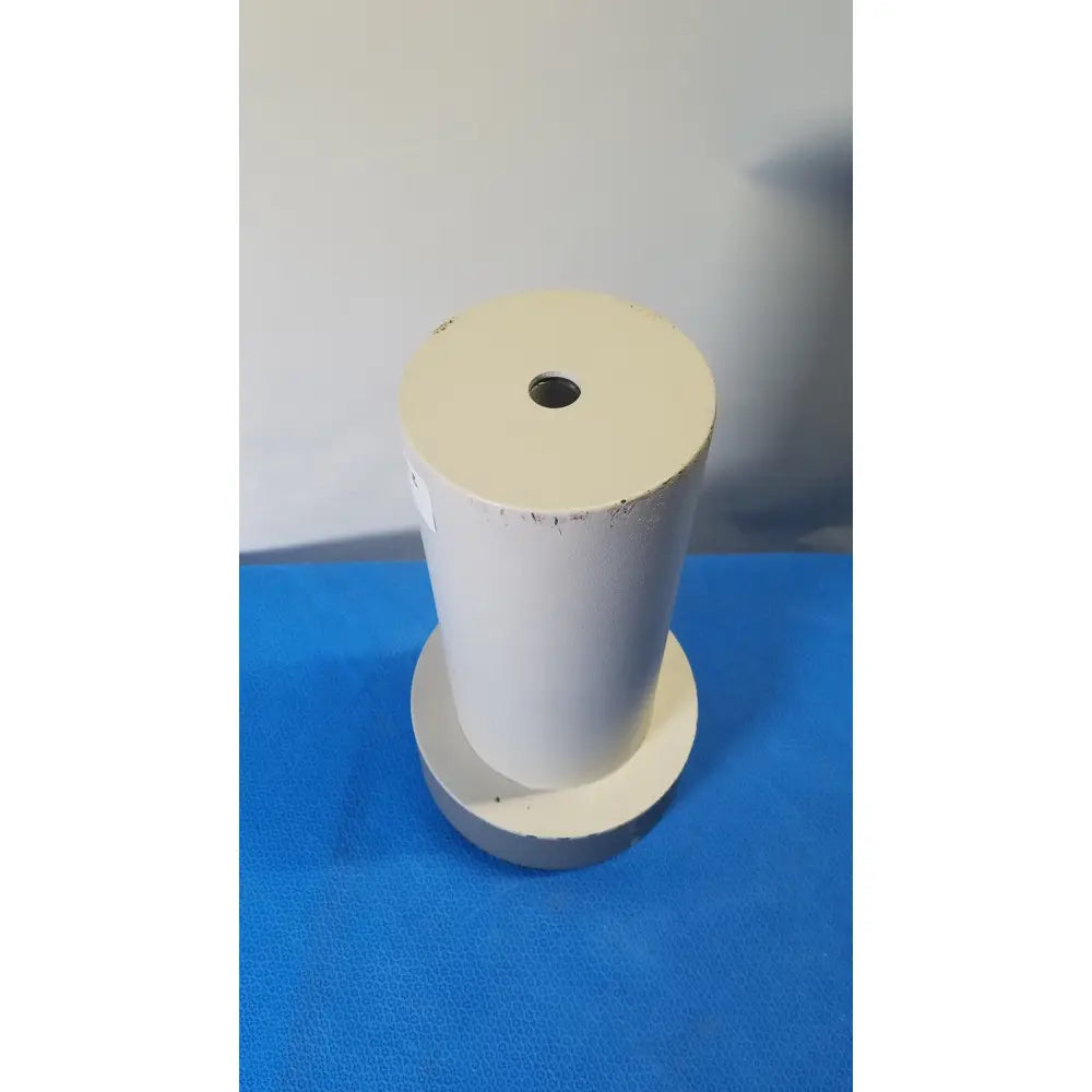 White cylindrical biodex well counter 187-602 with central hole and worn surface on circular base for reuse medical applications