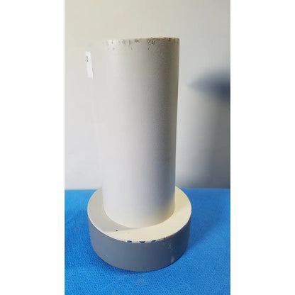 White cylindrical pipe with textured surface mounted on gray base for reuse medical in biodex well counter 187-602