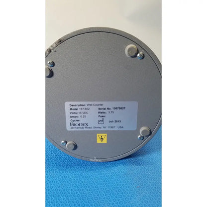Gray metallic circular biodex well counter model 187-602 with white label designed for reuse medical applications