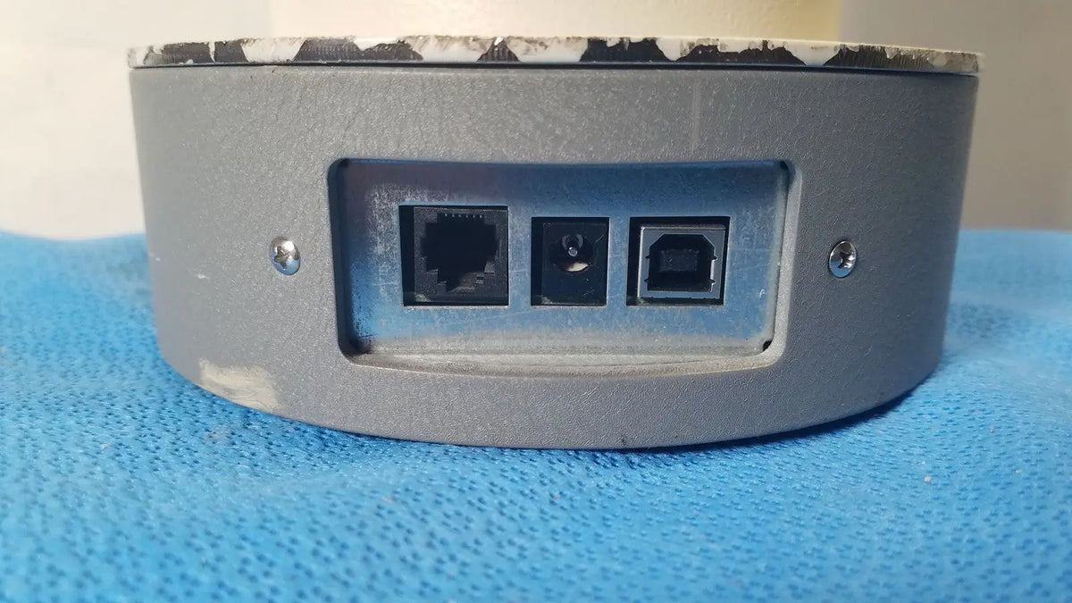 Back side of a gray cylindrical biodek well counter 187-602 network device with ethernet usb type-b and circular ports for reuse medical