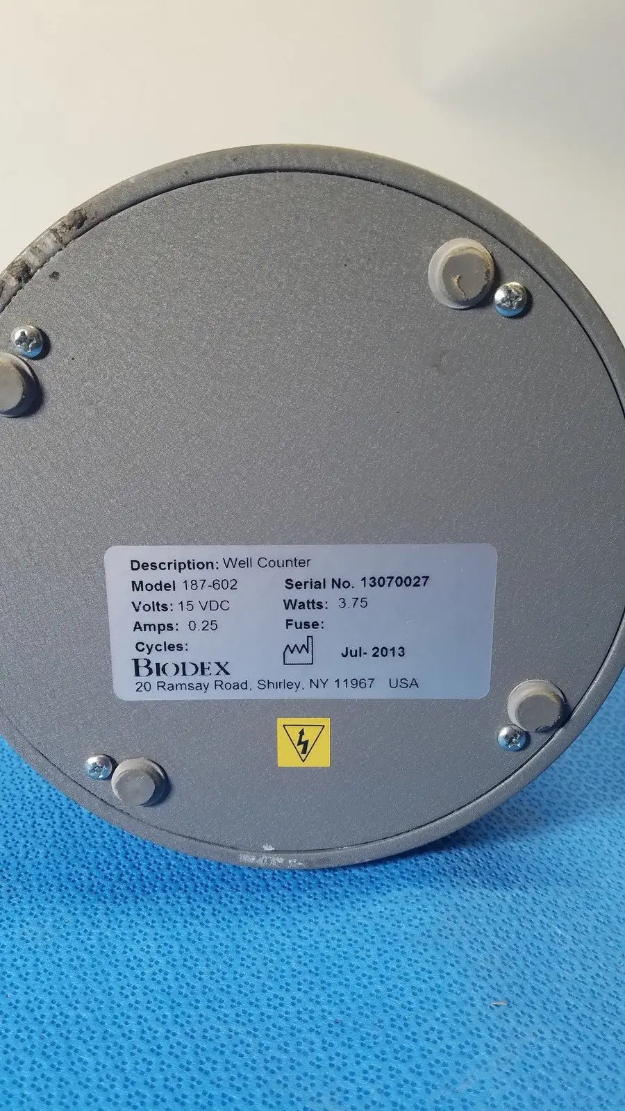 Gray metallic circular biodex well counter model 187-602 with white label designed for reuse medical applications