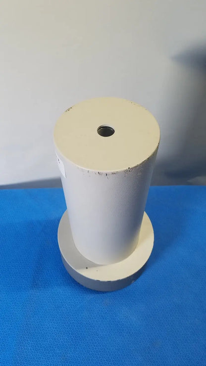 White cylindrical biodex well counter 187-602 with central hole and worn surface on circular base for reuse medical applications