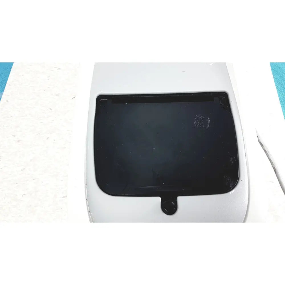 White plastic car sunroof with black glass panel and circular handle on biofire diagnostics filmarray 2.0 pcr system