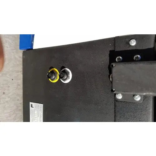 Black plastic housing with yellow and white threaded inserts secured by silver screws on biomerieux previ color gram automatic slide stainer
