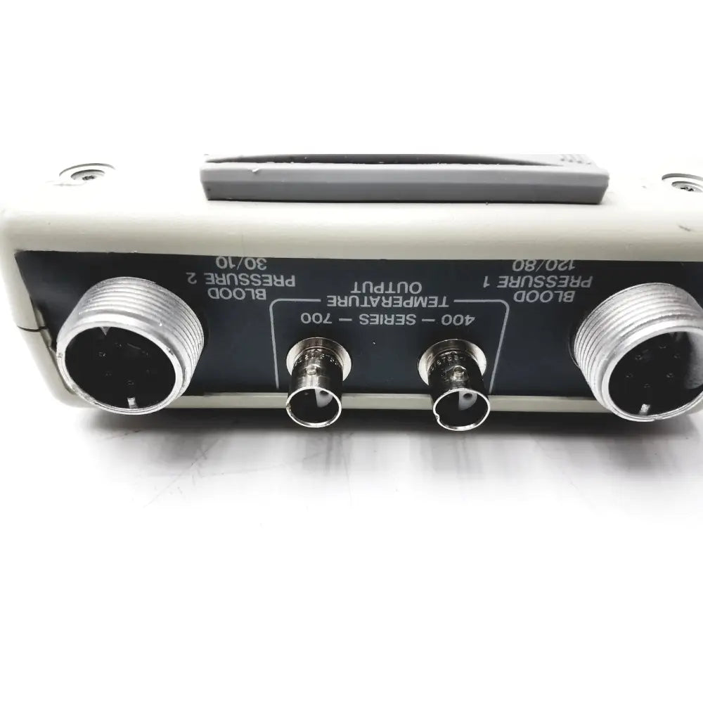 Back side of beige biotek lionheart multiparameter simulator with three metallic connectors for blood pressure and temperature output