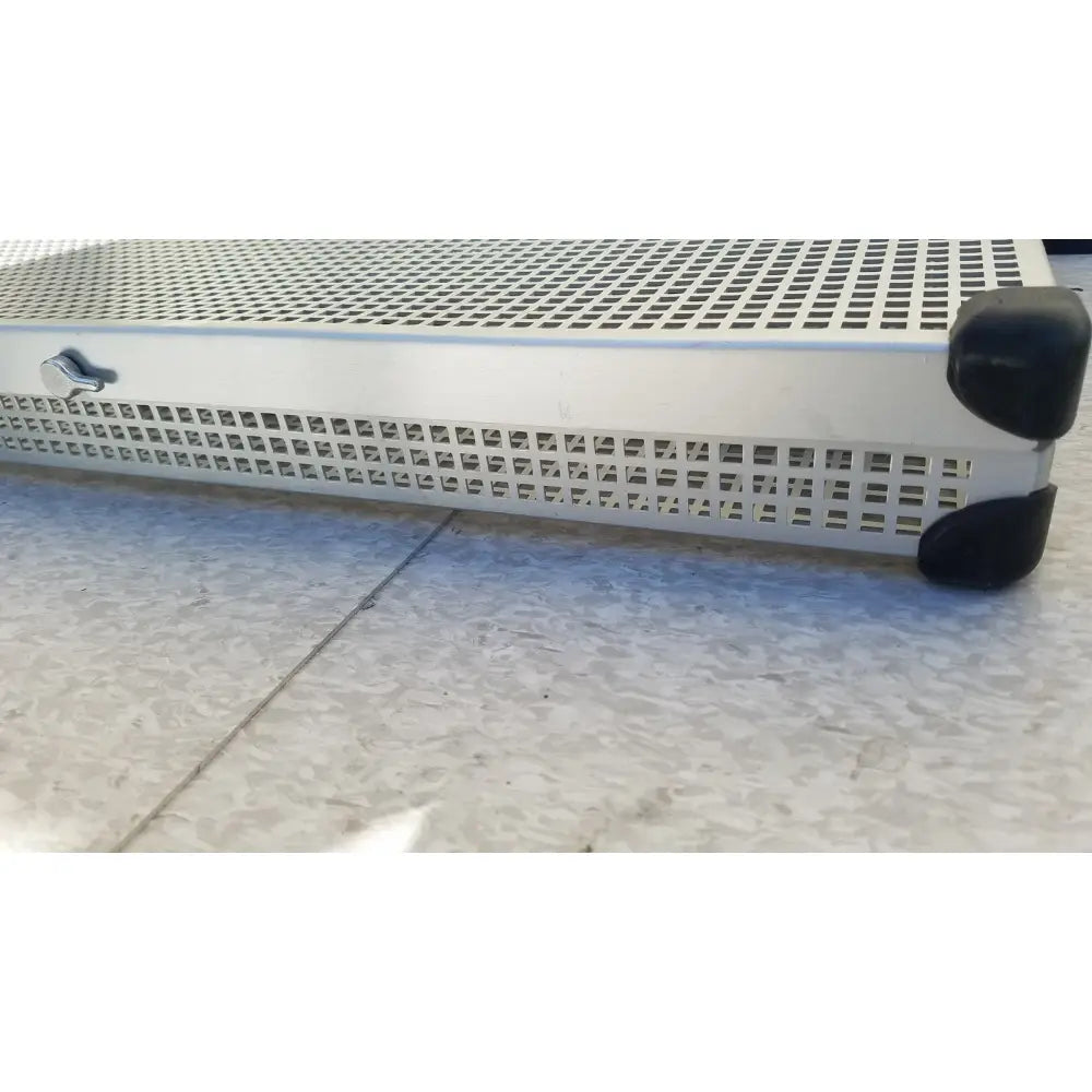 Silver perforated metal summit medical ua2438 instrument sterilization tray with black rubber feet and side latch