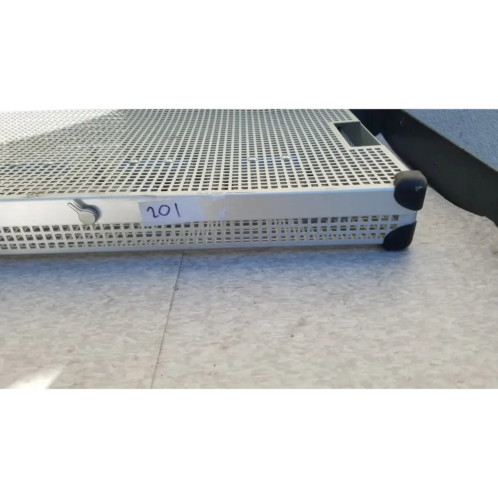 Silver perforated metal summit medical ua2438 instrument sterilization tray with black rubber protectors and label 201