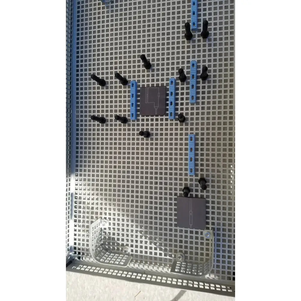 Gray perforated metal grid with black and blue plastic connectors in summit medical ua2438 instrument sterilization tray