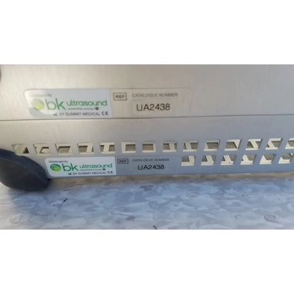 Gray metallic ultrasound machine with white summit medical ua2438 labels in bk medical instrument sterilization tray