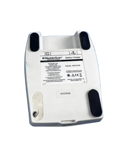 White plastic bladderscan battery charger with black rubber feet and label for reuse medical device 0570-0193