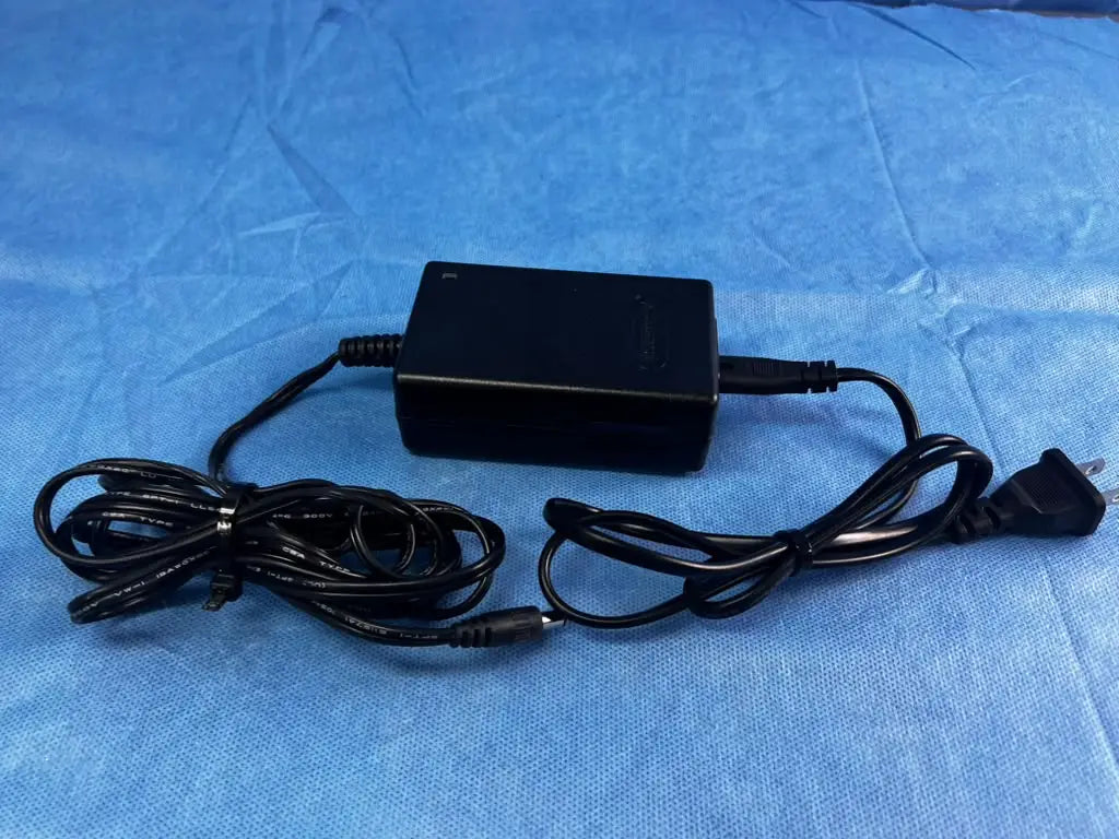 Black rectangular bladderscan battery charger 0570-0193 with coiled cables and standard plug for reuse medical devices
