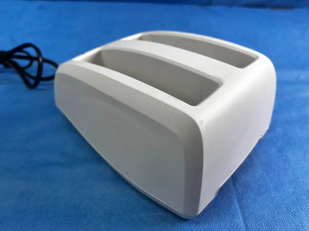 White plastic toaster with two slots and smooth rounded design shown as bladderscan battery charger 0570-0193
