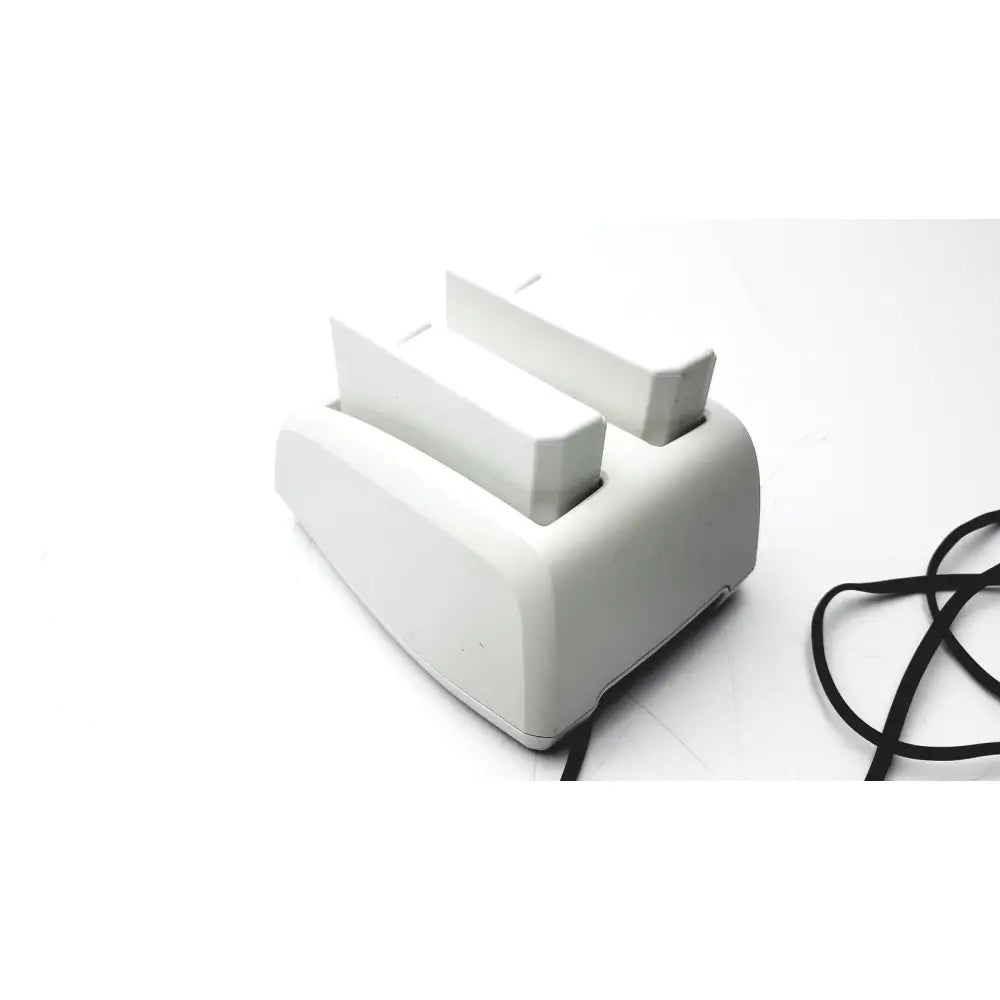White plastic bladderscan charging cradle verathon 0400-0066 with two slots and black power cord for charging