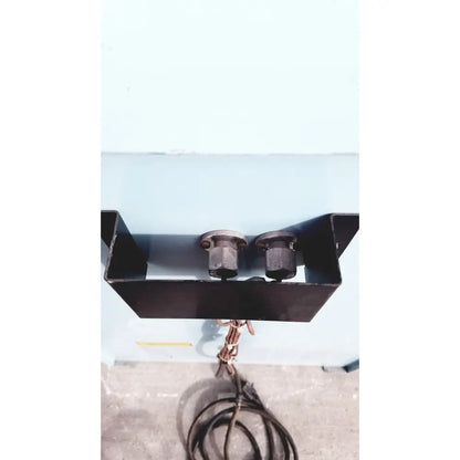 Black metal mounting bracket with two cylindrical fittings holding coiled brown cable on back of blue m ov-472a-3 constant temperature cabinet oven