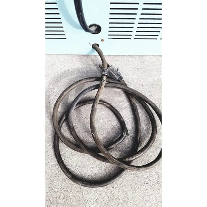 Coiled black electrical cord with frayed ends near a light blue vent of the blue m ov-472a-3 constant temperature oven