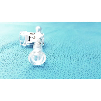 Clear plastic medical tubing with labeled connectors attached to a borosilicate glass stopcock adapter lab valve connector 24/40 joint